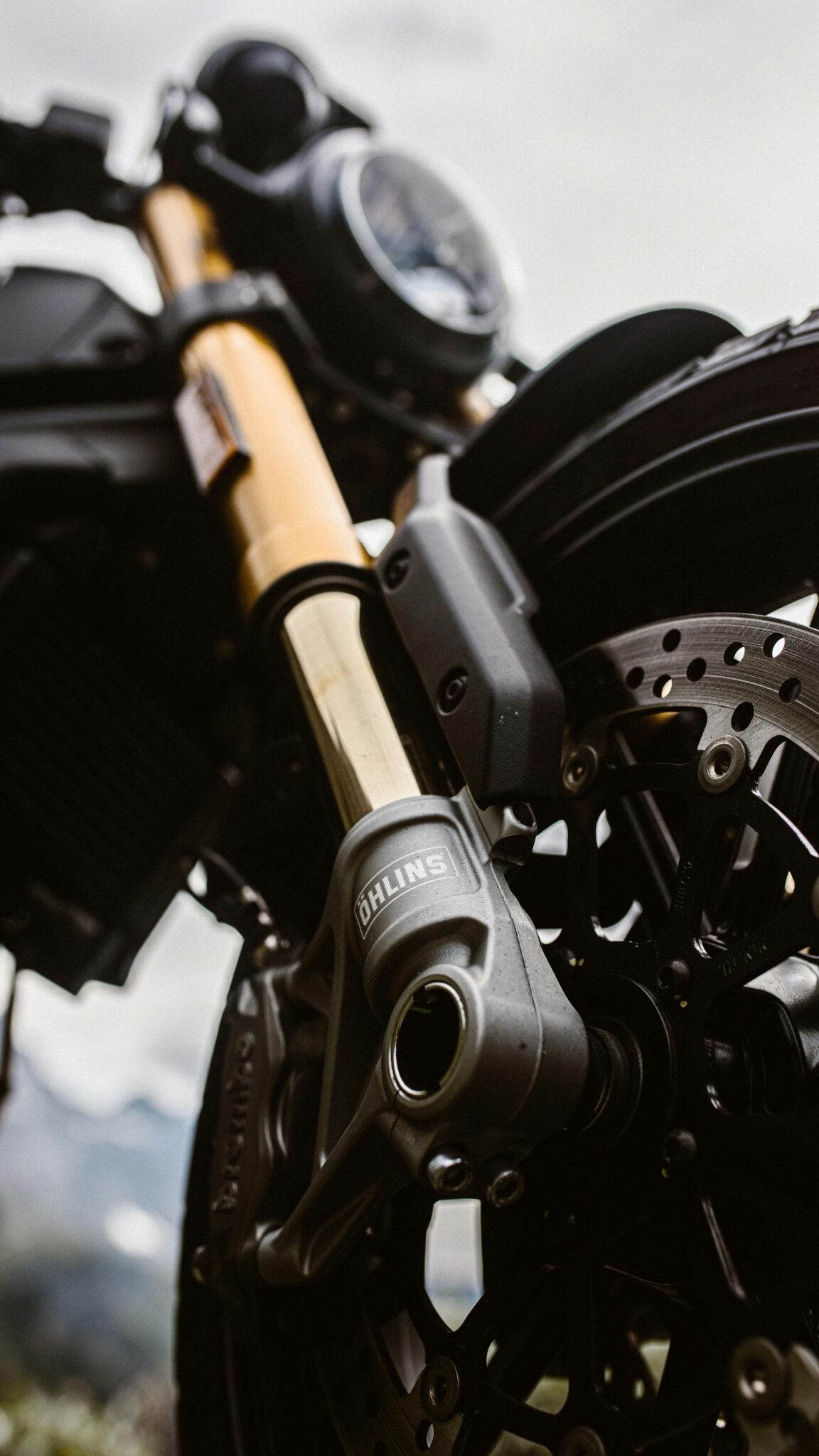 Low-angle shot of a motorcycle wheel showcasing suspension details.